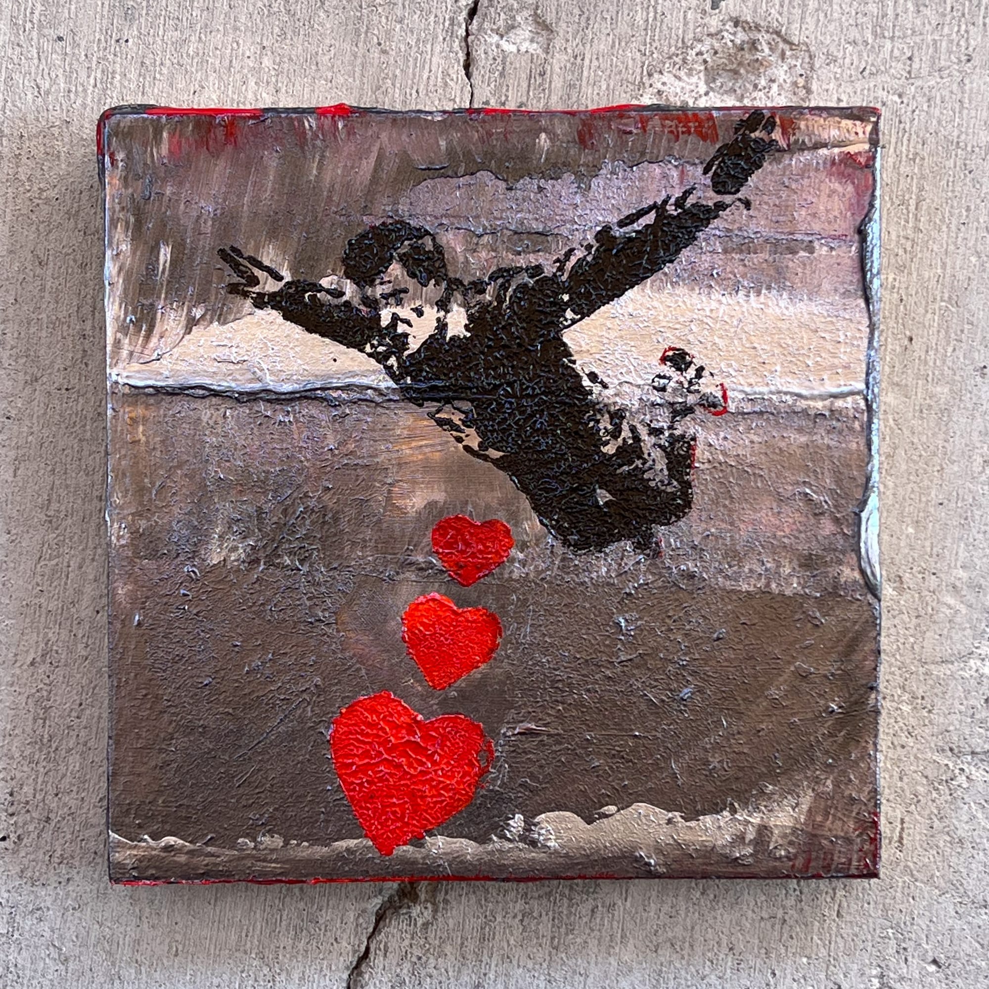 Textured silver acrylic painting where the muddled surface integrates the figure and hearts, binding the separate elements together.